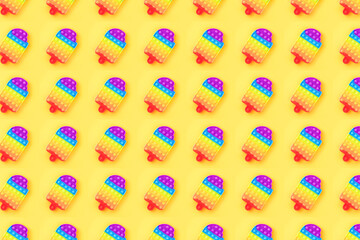 Pattern made from pop it toy isolated on yellow background.