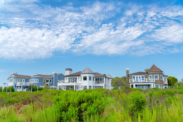 Fototapeta na wymiar Three large houses with glass fence at Newport Beach, Orange County, California