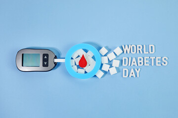 World diabetes day concept. Red blood drop in circle with Blood glucose test strip and Glucose meter. Top view
