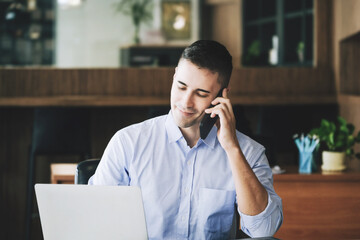 Male marketing manager using phone to talk to venture capital firm to increase profit potential.