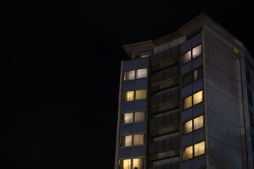 Large residential building with individual apartments at night