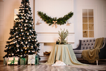 Warm cozy beautiful modern room design in gentle light colors decorated with a Christmas tree and decor elements for the new year