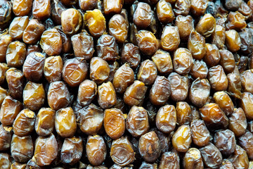 Sweet dates displayed at street market in Morocco, closeup detail