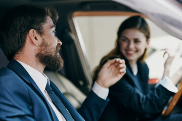 business man and woman driving a car transport