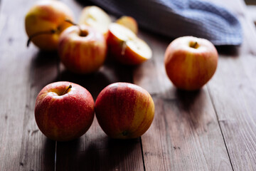 Red apples on a wooden table.