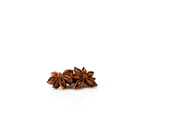Beautiful stars of anise on a white background with reflection, natural spices