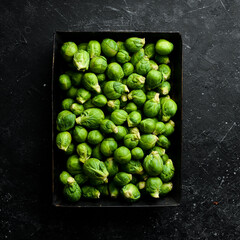 Brussels sprouts in a wooden box. Healthy food. Fresh vegetables. Top view.
