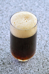 A glass of brown ale on the table