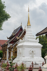 View of beautiful white ancient Lanna style stupa or chedi with golden spire inside historic Wat Prasat buddhist temple compound, Chiang Mai, Thailand - obrazy, fototapety, plakaty
