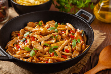 Traditional noodles with shimeji mushrooms and chicken. Prepared in a wok.