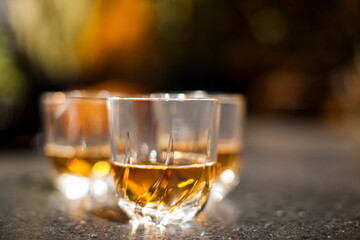 Whiskey glass close up in a dark bar setting. Selective focus on the glass. Copy space.High quality photo