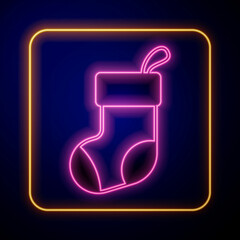 Glowing neon Christmas stocking icon isolated on black background. Merry Christmas and Happy New Year. Vector