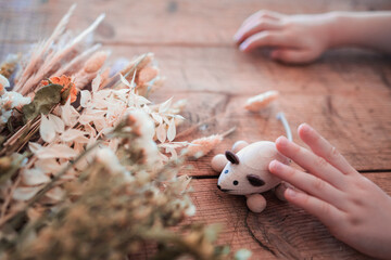 hand holding a wooden mouse