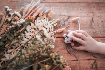 flowers and hand with wooden mouse