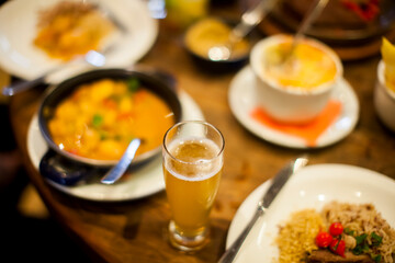 Group of people cheering with caipirinha drink glasses - Happy young friends enjoying lunch in a bar with food e drink -- Youth concept - High quality photo