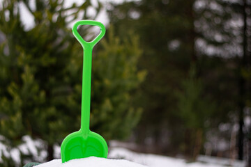 toy green shovel in the snow