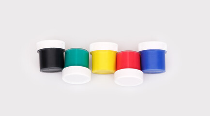 Bottles with multicolored gouache isolated on white background