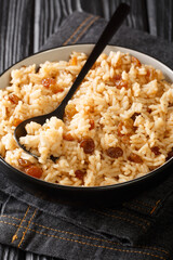 Authentic Colombian Arroz Con Coco Coconut Rice is a classic dish native to the Carribean coastal regions of Colombia close up in the bowl on the table. Vertical