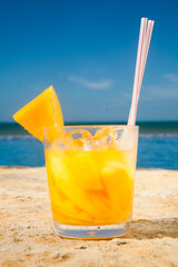 Brazilian caipirinha drink, fruits with Brazilian cachaa on the beach with blue sky