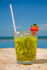 Brazilian caipirinha drink, fruits with Brazilian cachaa on the beach with blue sky