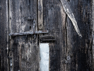 Closing details of an old wooden barn door