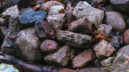 Abstract background with pebbles, round sea  pebbles and stones, wet, texture, background in high resolution pattern for backdrop Heap of colorful dry round stones background, top view