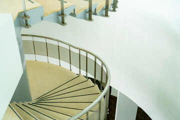 The curved steel staircase goes up to the second floor. with stainless steel handrails The stairs...
