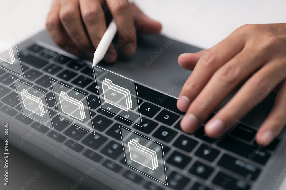 Aufkleber paperless workplace concept based on e-documents. on a virtual screen, a businessman works on a lapt