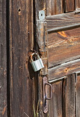 Locked old castle on the canopy of a wooden shed close-up