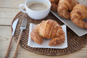 Croissants and coffee on a rustic background