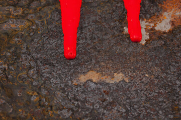 Two streaks of red paint on a piece of old rusty steel, abstract, background.