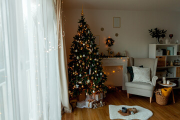 Living room with Christmas decorations. Christmas tree, gift boxes, cozy armchair, pillows, fireplace.