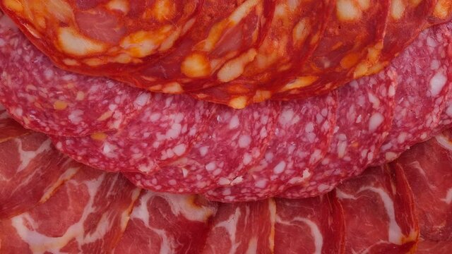 Sausages. Different types of sausages top view, rotating. 4K UHD video