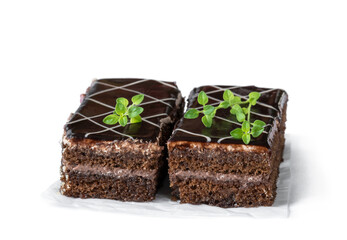 Slices of chocolate cake with cream isolated on white