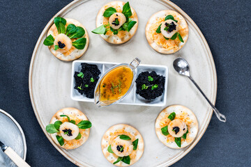 Canapes with scallops, caviar and lime and butter sauce