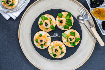 Canapes with scallops, caviar and lime and butter sauce