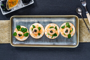 Canapes with scallops, caviar and lime and butter sauce