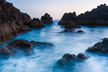 Fototapeta na wymiar Waves at rocky coast of Madeira