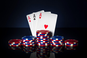 Obraz premium Poker game with three of kind or set combination. Chips and cards on table. Successful and win three aces