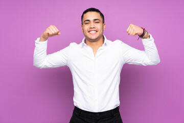 Asian handsome man isolated on blue background doing strong gesture