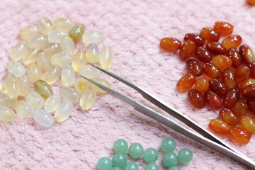 Natural Color gems stone on pink fabric. Golden smith and gems and jewelry