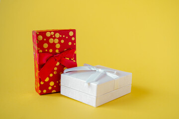 Top view of red and white gift box on yellow background