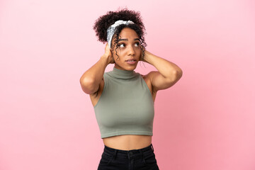 Young latin woman isolated on pink background frustrated and covering ears