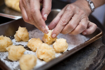 Cooking food. Hands of woman cooking fried cakes in the kitchen. Chef at restaurant cooking. High quality photo