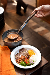 Cooking food. Hands of woman cooking rice and beans in the kitchen. Chef at restaurant cooking. High quality photo