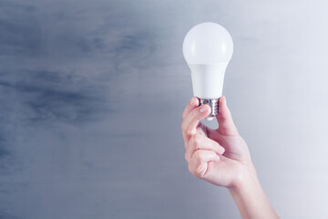 a woman's hand holding a light bulb