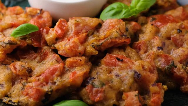 Greek tomato fritters, tomatokeftedes served with yogurt. Rotating video