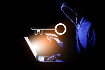 hacker presses key on laptop