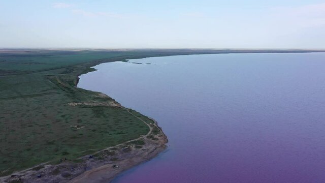 The coastline of the pink lake. Lake Lemuria (Pink Lake) is a lake in the Kherson region of Ukraine. Aerial view