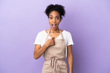 Restaurant waiter latin woman isolated on purple background with surprise facial expression